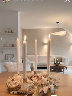 candles are arranged on a table in the middle of a living room