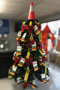 a small christmas tree decorated with ribbons and tags in an airport terminal lobby or waiting area