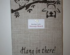 there is a sign that says hang in there with two owls sitting on a tree branch