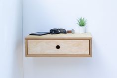 a pair of black flip flops sitting on top of a wooden drawer