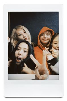 a group of women standing next to each other in front of a white photo frame