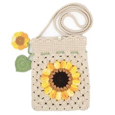 a crocheted bag with a sunflower on the front, and a flower in the middle