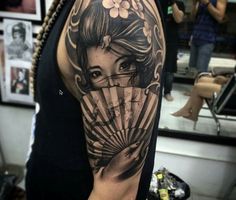 a woman with a fan tattoo on her arm