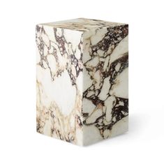 a white and brown marble block on a white background