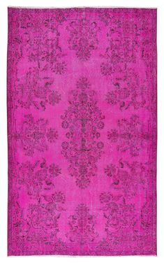 a pink rug with an ornate design on the middle and bottom, in different colors