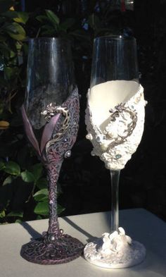 two wine glasses sitting next to each other on a table