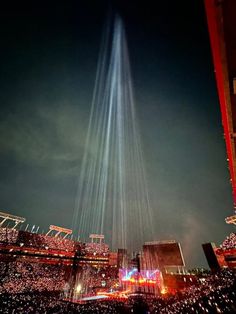 the lights in the sky are shining brightly over a cityscape at night time