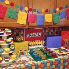 a lego themed birthday party with cupcakes, cake and candy bars on the table