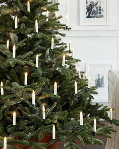 a christmas tree with lit candles on it