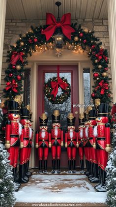 christmas decorations on the front door of a house with nutcrackers and wreath