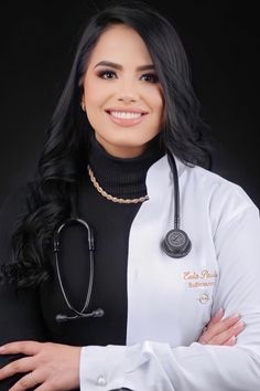 a woman wearing a white coat with a stethoscope on her neck and arms crossed