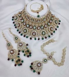 Description: Enhance your elegance with this stunning Traditional Indian Kundan Necklace Set featuring matching earrings, meticulously crafted to perfection. This exquisite jewelry set is the epitome of luxury, blending traditional design with contemporary flair, making it a must-have for every jewelry collection. Product Features: Material: High-quality Kundan stones, gold-plated alloy, and pearl detailing. Design: Intricately designed with a beautiful combination of beads that add a pop of color, perfect for any occasion. Earrings: Matching earrings with a comfortable fit, complementing the necklace perfectly. Necklace Length: Adjustable with a drawstring closure to suit your neckline and preference. Occasion: Ideal for weddings, bridal wear, engagements, festive occasions, and parties. Kundan Choker Necklace, Earrings Matching, Kundan Necklace Set, Kundan Choker, Kundan Necklace, Bollywood Jewelry, Necklace Bridal, Kundan Necklaces, Indian Bollywood