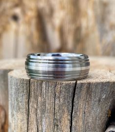 a wedding ring sitting on top of a piece of wood