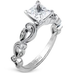 an engagement ring with a princess cut diamond in the center and vine design on the band