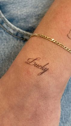 a woman's arm with a name tattoo on it