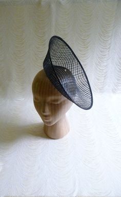 "One hat base with a 3.75\" tall upturned brim made in black stiffened sinamay straw that measures approximately 11\" (27.94 cm) in diameter at the top. The base is contoured to fit against the head. The edges of the brim are finished in sinamay. The multi-layer stiffened sinamay straw has a very delicate look but it has a great sturdy weave and provides excellent support for your millinery creations. This is NOT a finished hat and will not stay on your head unless you add a head band to wear. A Fitted High Crown Fascinator For Church, Black Sinamay Fascinator For Kentucky Derby, Black Sinamay Fascinator For Summer, Fitted Black Boater Hat For Races, Fitted Black Sinamay Hat, Black Fitted Sinamay Hat, Fitted Sinamay Costume Hat For Church, Brimmed Sinamay Fascinator For Church, Black Fitted Fascinator With Structured Crown