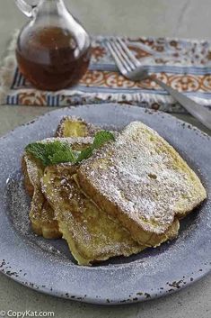 french toast with powdered sugar and mint on a plate