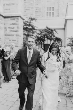 a bride and groom walking down the street