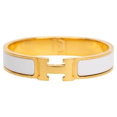 The Hermes Clic Clac H, narrow bracelet in white enamel with gold-plated hardware. Size PM, new in unworn condition, comes with velvet pouch. Classic Formal Bracelets With Gold-tone Hardware, Classic Gold-tone Bracelets For Formal Occasions, Timeless Formal Bracelets With Gold-tone Hardware, Timeless Formal Bracelet With Gold-tone Hardware, Timeless Gold-tone Bracelets For Formal Occasions, Timeless Formal Gold Bracelets, Chic White Bracelets For Formal Occasions, Modern White Bangle For Formal Occasion, Designer White Bangle Bracelets