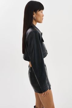 The XANDY Cropped Leather Jacket flatters the body with its dynamic silhouette. Cuffed long sleeves exude effortless cool, while the flap chest pocket adds utilitarian charm. Whether casually draped over the shoulders for a chic daytime ensemble or paired with the LIANA Leather Hot Skort for a sleek evening look, this statement piece is destined to become a wardrobe staple. Short Cuir, Cropped Leather Jacket, Jupe Short, Jeans Button, Leather Jacket Black, Black Xs, Chest Pocket, Wardrobe Staples, Leather Jacket