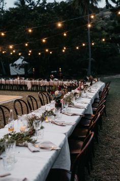 a long table is set up with candles and place settings