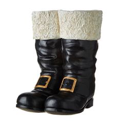 a pair of black and white boots with fur on the top, two buckles at the bottom