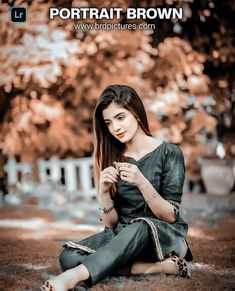 a beautiful young woman sitting on the ground