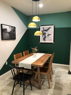 a dining room with green and white walls