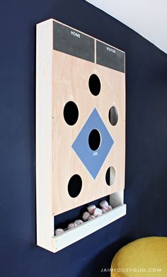 a wooden board with holes in it mounted on the wall