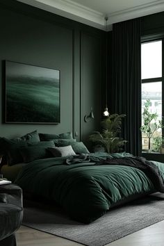 a bedroom with dark green walls and large windows