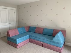 a blue and pink couch sitting in a living room