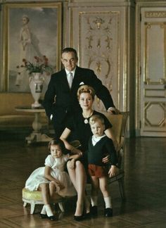 an older man and two young children sitting on a chair