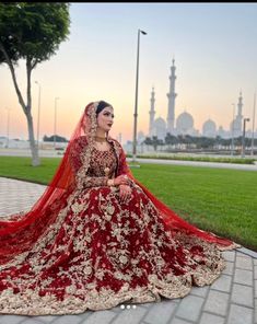 a woman in a red and gold wedding dress