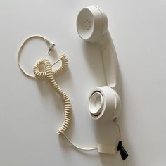 an old style telephone is plugged in to the wall with a cord and charger