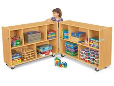 a child's play room with shelves and toys on the floor, including bookshelves