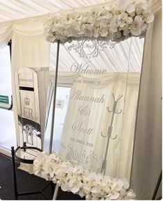 a white wedding arch with flowers on it