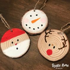 three wooden ornaments with faces painted on them