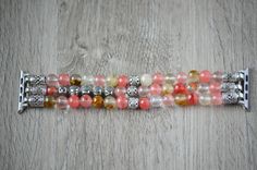 "This lovely beaded iwatch band is made from genuine Cherry Quartz stone and silver plated findings. Beads are 8mm round and total weight is 56 gram for 5\" long band. You can personalize your band by adding up to 8 letters to it. Letter beads are silver plated and double-sided. The watch band fits all iwatch as long as you select the right iwatch size (38mm, 40mm, 42mm or 44mm). There are no clasps, the cord can stretch. Measure your wrist tightly and select your SIZE from the drop-down menu. T Silver Adjustable Apple Watch Band With Round Beads, Silver Beaded Bracelets With 108 Round Beads, Silver Agate Crystal Bracelet With Round Beads, Silver Beaded Bracelets With Round Beads, Apple Watch Bracelet, Apple Watch Bracelets, Custom Jewelry Box, Cherry Quartz, Band Fits