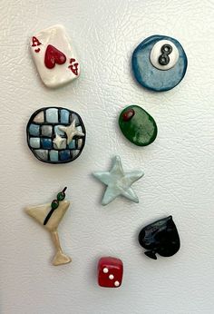 a refrigerator with magnets on the side of it and different colored objects attached to it