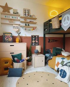 a child's bedroom with two bunk beds and various decorations on the wall above them