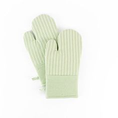 two green oven mitts sitting next to each other on top of a white surface