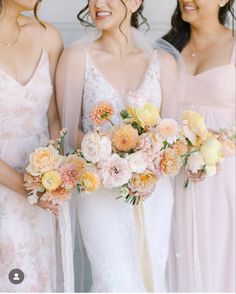 three bridesmaids holding bouquets of flowers in their hands