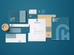 an assortment of stationery and envelopes on a blue background with the letter q