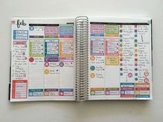 an open planner book with lots of stickers on the pages and words in it