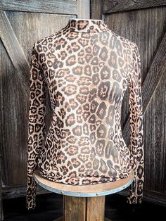 This top is one of our favs!!! We designed this sheer long sleeve top with kitty leopard!! Wear this top under a short sleeve tee or top for a layering look or as a regular top with a cute tank or tube top underneath! This top is super comfy and true to size! MESH TOP ONLY! All other items pictured are sold separately! 96% POLYESTER 4% SPANDEX SIZE CHEST LENGTH SLEEVE WIDTH SLEEVE LENGTH S 17" 25" 3.5 23" M 18" 25.5" 3.75" 23.5" L 19" 25.75" 4" 23.75" XL 20" 26" 4.5" 24" 2X 22" 26.5" 4.75" 24.25 Casual Mesh Moisture-wicking Tank Top, Spring Crew Neck Printed Mesh Top, Western Mesh Top, Leopard Print Mesh Top, Black Tiger Print Long Sleeve Tops, Sheer Long Sleeve Top, Belted Sweater, Dolman Top, Wrap Boots