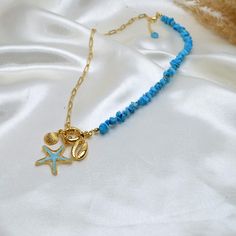 The product is designed with turquoise turquoise broken natural stones and detailed with gold-plated chain, star and seashell; Contact with water, cream and perfume should be avoided; Delicate use is recommended; Turquoise Jewelry With Starfish Charm As Gift, Turquoise Jewelry With Starfish Charm For Gift, Turquoise Jewelry With Starfish Charm For Vacation, Blue Charm Necklaces For The Beach, Handmade Gold Turquoise Necklace For Beach, Gold Necklaces With Natural Stones For Beach, Turquoise Necklace With Starfish Charm For Jewelry Making, Turquoise Necklace With Starfish Charm As Gift, Turquoise Necklace With Starfish Charm For Gift