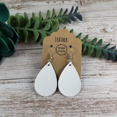 "These mini white teardrop petal leather earrings make a great statement, yet simple and easy for everyday wear.  They feature a shiny line texture to them and are lightweight and sure to pair perfectly with any outfit!  They also make great gifts for moms, daughters, grandmothers, sisters, friends, teachers, coworkers, and more! *Size = Mini = 1.5\" long x 1\" wide with a drop length of 2\" *last photo shows other styles and sizes listed elsewhere in the store - these are the Mini Teardrop* *Thickness = 1.0mm = average* > Durable > Noise free > Affordable > Nickel free fishhook ear wire > Rubber backs included so you can wear them without losing one! I have a variety of colors and styles to choose from so be sure to view my other listings: https://bethwolfhandmade.etsy.com All items are m Adjustable Trendy Teardrop Earrings For Gifts, Trendy Adjustable Teardrop Earrings For Gift, Handmade White Leather Earrings, Adjustable White Teardrop Dangle Earrings, Minimalist Adjustable Hypoallergenic Teardrop Earrings, Everyday White Drop Earrings, White Dangle Teardrop Earrings, Adjustable Nickel-free White Teardrop Earrings, Nickel-free White Dangle Teardrop Earrings