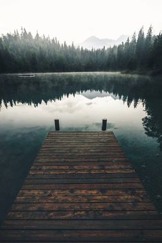 a wooden dock sitting on top of a lake