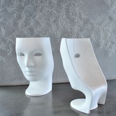 three white mannequin heads sitting next to each other