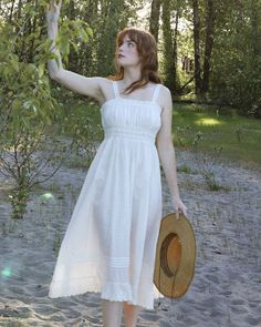 Rendered in a warm off white cotton, the Seville Dress is our floaty white summer dress dreams come true. Features lace accent on gathered bodice with lace inserts at the waist finished with self ties on the side for a feminine touch. Hem of dress is accented with rows of pintuck pleats and embroidered broderie anglais lace ruffle flounce. Hidden side zipper. Material:100% Cotton Sheerness:❦❦❦❦❦- 3 out of 5 - Somewhat Sheer Garment Care:For best results, gently hand wash and lay flat to dry Prod Edwardian Chemise, 1940s Evening Dresses, Pintuck Pleats, Vintage Sundress, Women Dress Collection, Gored Skirt, Gathered Bodice, White Summer Dress, Bias Cut Skirt